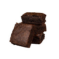 Stack of dark chocolate brownies on a white background.